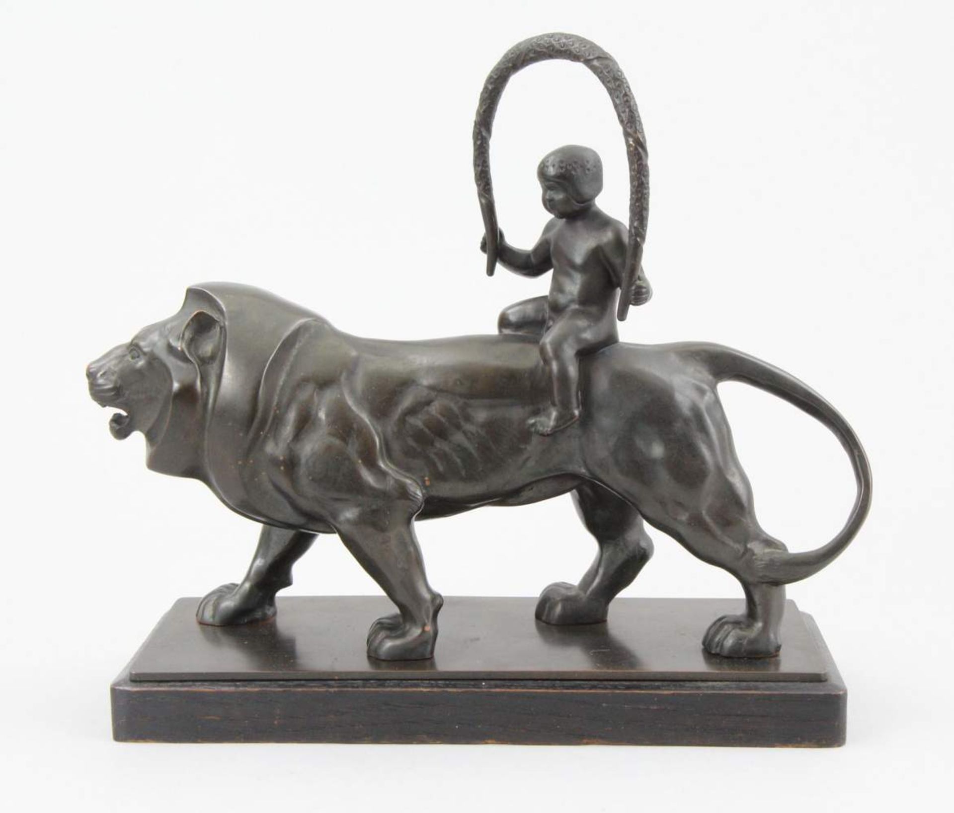 Germn early 20th century sculptor Figure, patinated bronze, naked boy riding a lion, original wooden