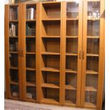 Bücherschrank mit vier verglasten Türen, mittleres Fach offen, hellbraun gebeizt. 219 x212 x 42cm;