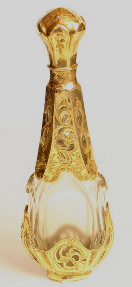 Gold mounted crystal scent bottle the base and top gold mounted and pierced with scrolling.