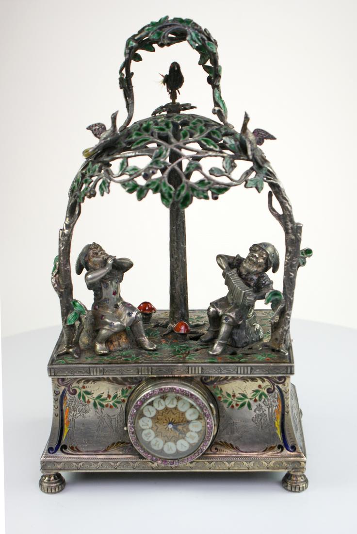 A fine and rare Silver and gem set singing bird in tree The base set with a clock with ruby bezel