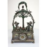 A fine and rare Silver and gem set singing bird in tree The base set with a clock with ruby bezel