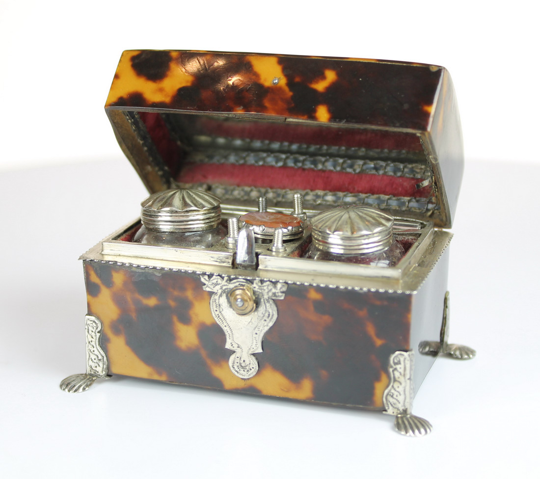 A fine Tortoiseshell travelling writing set of trunk form on 4 silver mounted feet opening to