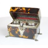 A fine Tortoiseshell travelling writing set of trunk form on 4 silver mounted feet opening to