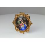 A fine Swiss gold and enamel brooch depicting Madonna and child. Geneva, c1840. The plaque