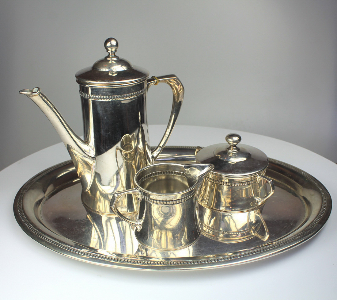 A 3-piece coffee set depicting a miniature coffee pot, sugar and cream jug on a tray marked 800,