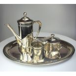A 3-piece coffee set depicting a miniature coffee pot, sugar and cream jug on a tray marked 800,