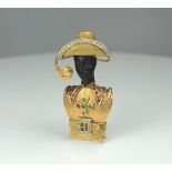 A ruby and emerald brooch depicting a Blackamoor, marked 18ct 750. The model wearing diamond set hat