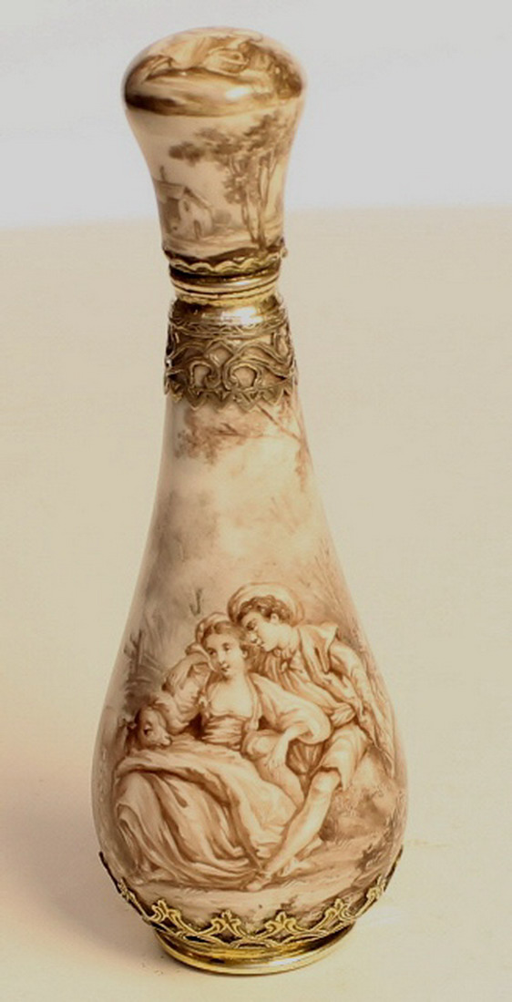 A French enamel perfume bottle , with pieced silver mount to neck and base in an attractive