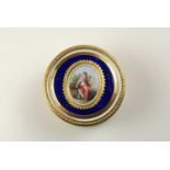 The circular box with two colour gold mounts central enamel plaque of a beauty holding a bird