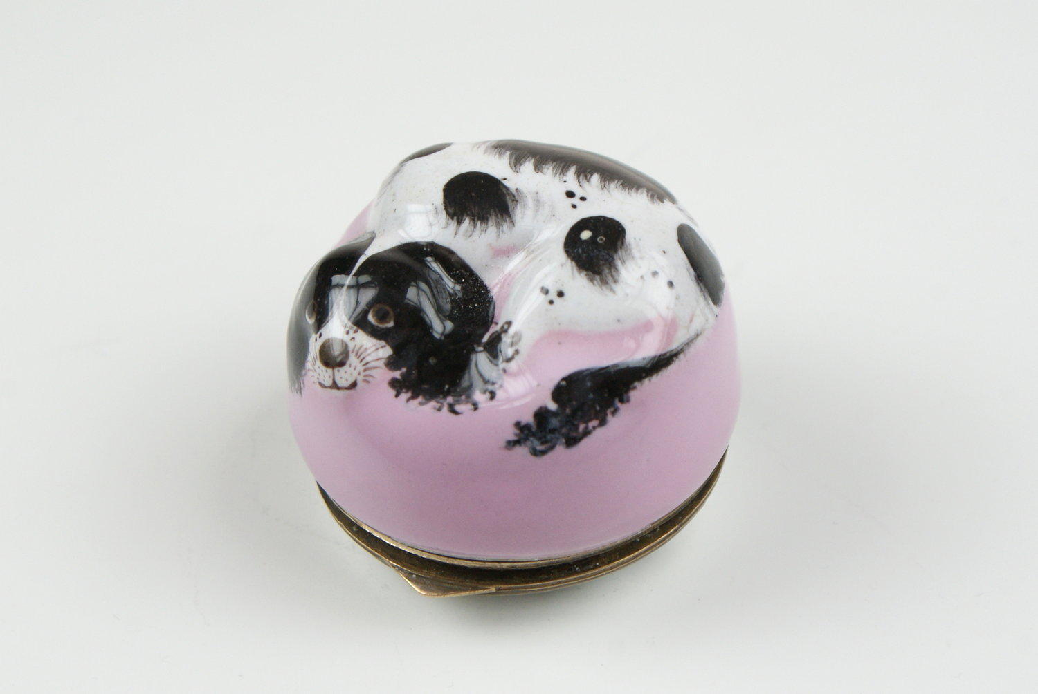 The Black and white  embossed Spaniel curled on a pink cushion  The white base with sprays of summer