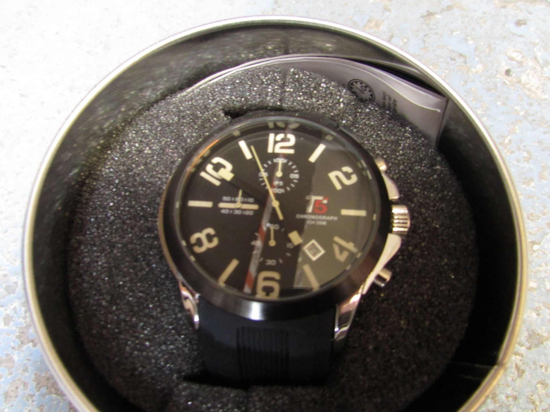 The T5 Lennox L1 watch features a black chronograph dial, black hands, with off white numbers. - Image 2 of 2