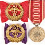 3 AUSZEICHNUNGEN: Rot Kreuz-Verdienstmedaille in Silber, a. Bd.; 2 Ehrenzeichen der Handelskammer