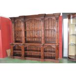 A substantial stained pine bookcase, ste