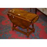 A small drop leaf occasional table serpe