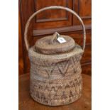 A rattan snake basket, single loop handl