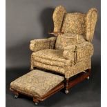 An Edwardian oak wingback adjustable con