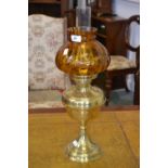 A brass and glass oil lamp, amber onion