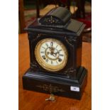 A black slate mantel clock, architectura