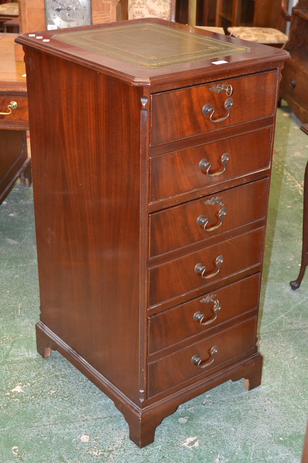 A reproduction mahogany filing cabinet