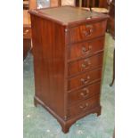 A reproduction mahogany filing cabinet