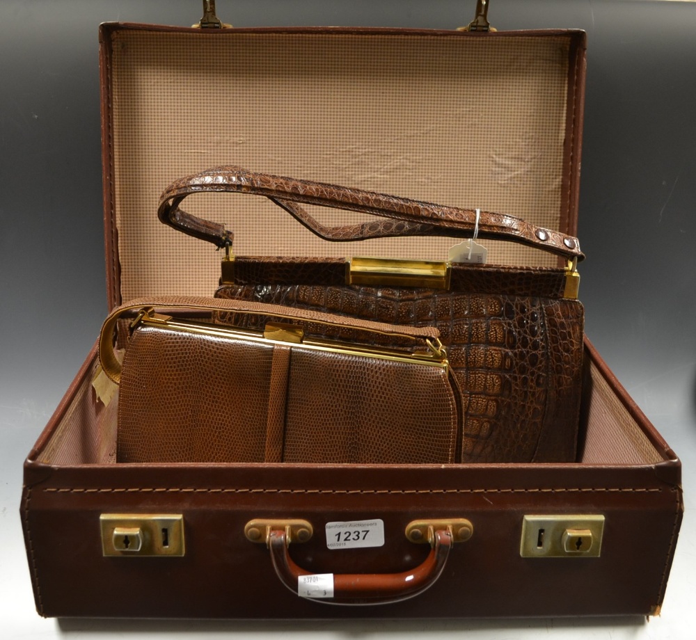 A brown suitcase; two handbags (3)