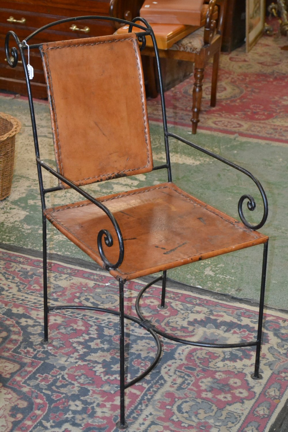 A Spanish cast iron and hide armchair, c