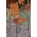A Spanish cast iron and hide armchair, c