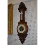A Victorian carved oak aneroid wall baro