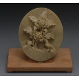 A Chinese soapstone oval plaque, carved