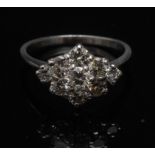 A nine stone diamond cluster ring, centr