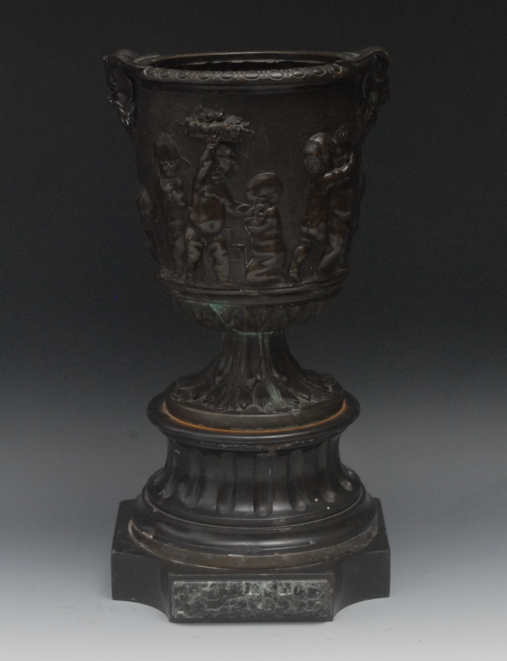 A 19th century bronze urn, in relief wit