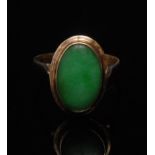An emerald green jade cabochon ring, ova