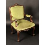 A substantial Victorian mahogany elbow chair, cartouche shaped back, outswept arms, boldly carved