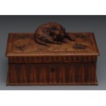 A 19th century German Black Forest jewellery casket, the hinged cover carved with a recumbent hound,