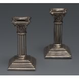 A pair of miniature silver Corinthian ca