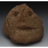 An archaic stone head, carved with styli