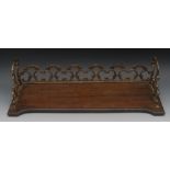 A William IV mahogany and gilt metal book trough, three-quarter gallery pierced and cast with