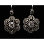 A pair of diamond flower head earrings,