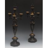 A pair of 19th century French bronze four branch candelabra, the branch and vine supports below