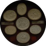 An arrangement of Grand Tour plaster intaglios, circular frame, 22.5cm diam