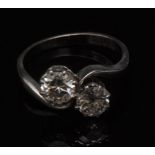 A diamond two stone crossover ring, set