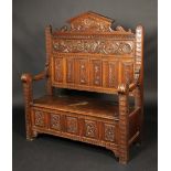 A Victorian oak hall settle, shaped cres