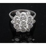 A thirteen stone diamond flowerhead ring