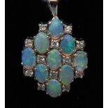 An opal and diamond lozenge pendant, set