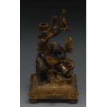 A 19th century gilt and patinated bronze novelty desk top taperstick, amusingly cast as a dog