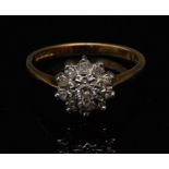 A diamond flower head ring, set with ele