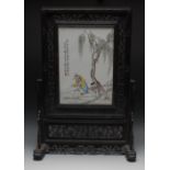 A Chinese porcelain table screen, the rectangular panel painted with script and in polychrome with