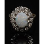 An opal and diamond ring, the central wh