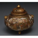 A Japanese satsuma globular pot pourri vase and cover, decorated overall with figures in shaped