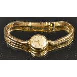 A lady's 18ct gold Omega watch and strap